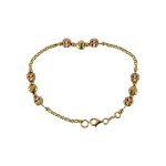 Pulsera de oro combinado amarillo y rosa modelo roló con corazones y tréboles